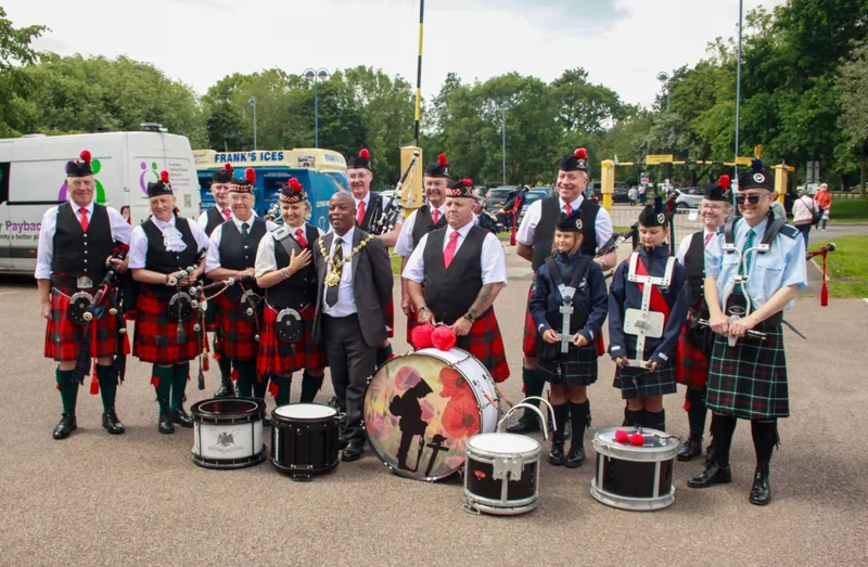 Bomber County Pipes & Drums lined up with their crested bass drum at a showground
