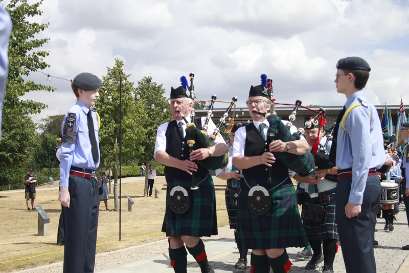 Pipers playing alongside air cadets at a town event